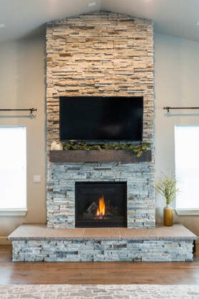 indoor two toned stone fireplace and mantle