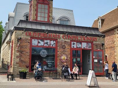Brick building of confectionery store with people sitting at tables outside the store in Unionville, Markham, Ontario