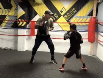 Adult and child boxing in Wismer Commons, Markham, Ontario