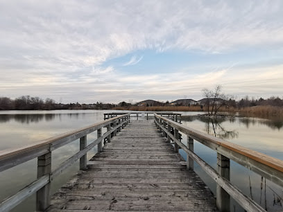 Wooden boardwalk leading to a pond in Greensborough, Markham, Ontario